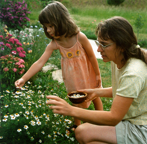 Sharon and Kaya picking flowers in their yard