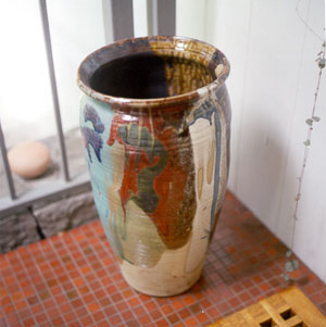 A large, colorful ceramic vase next to the entrance