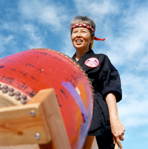 Mom in front of one of the group's Taiko drums